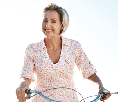 Photo of a woman smiling and riding a bicycle