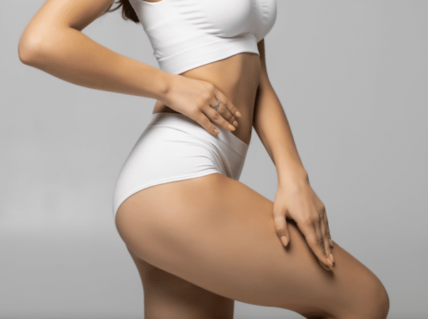 photo of female lower torso and upper legs in white swimsuit